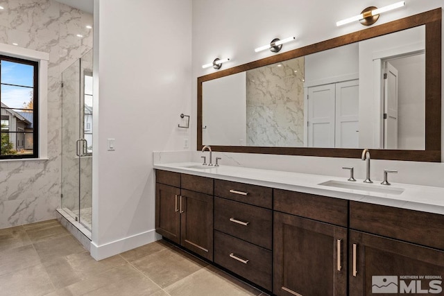 4090 Goodsell Ln, Reno, NV 89523 - full bath with a marble finish shower, double vanity, baseboards, and tile patterned flooring