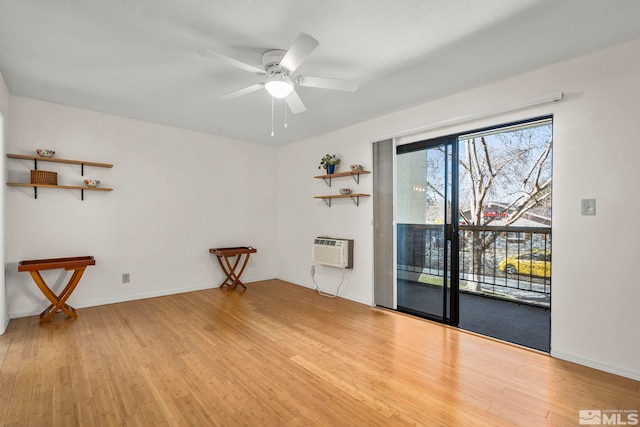 2450 Lymbery St Unit 206, Reno, NV 89509 - spare room with light wood-type flooring, ceiling fan, a wall mounted AC, and baseboards