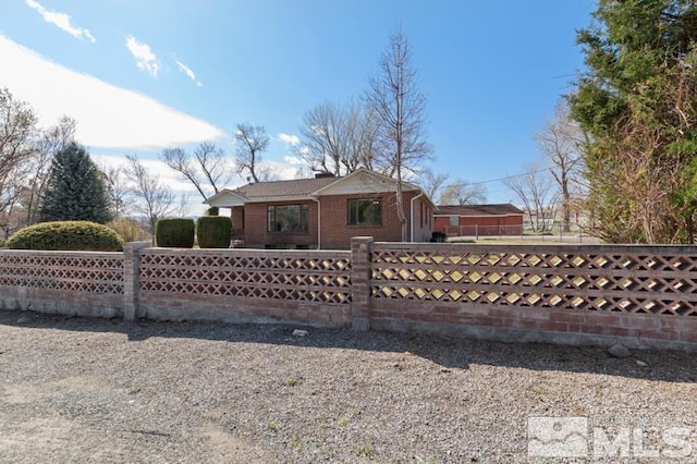 back of property with brick siding and a chimney