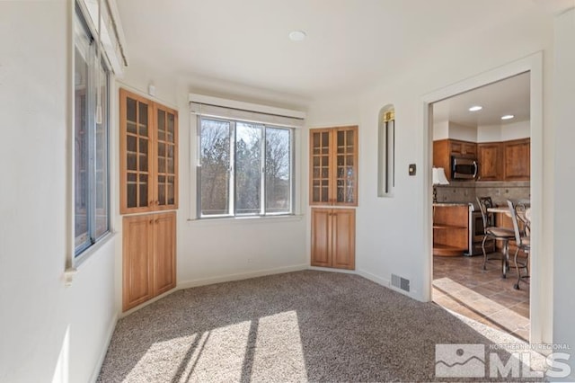 carpeted empty room featuring recessed lighting and baseboards