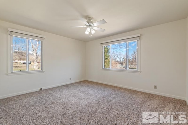 carpeted empty room with baseboards and ceiling fan