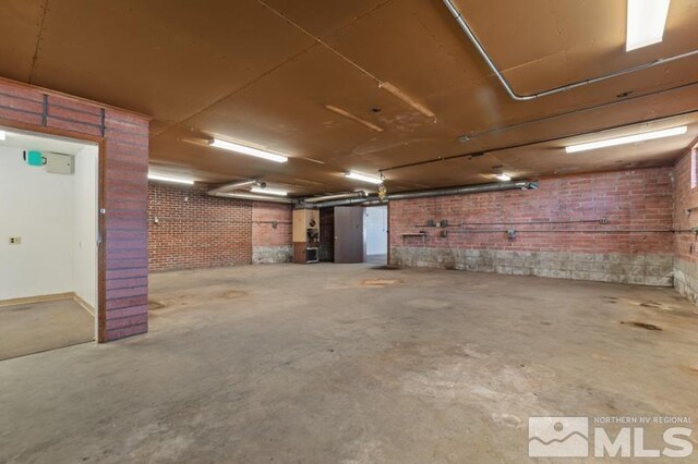 below grade area featuring brick wall