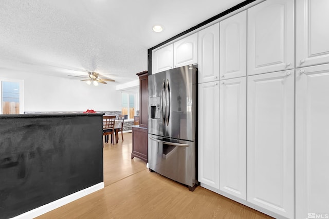 6357 Moon Ridge Ter, Reno, NV 89523 - kitchen with stainless steel refrigerator with ice dispenser, light wood-style floors, a ceiling fan, a textured ceiling, and white cabinetry