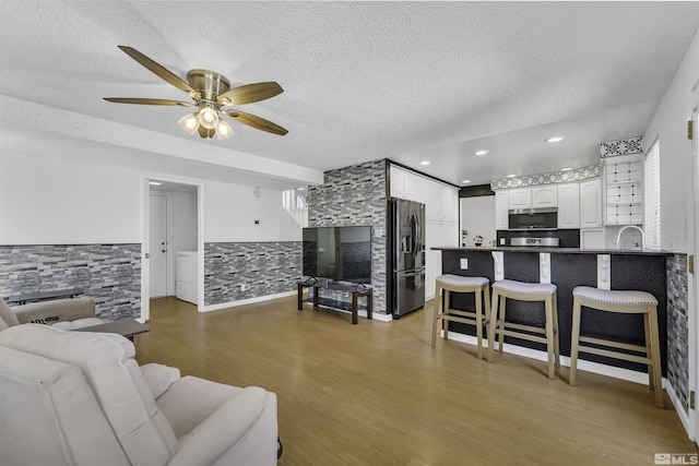 6357 Moon Ridge Ter, Reno, NV 89523 - living room with a textured ceiling, a ceiling fan, wood finished floors, and washer / clothes dryer