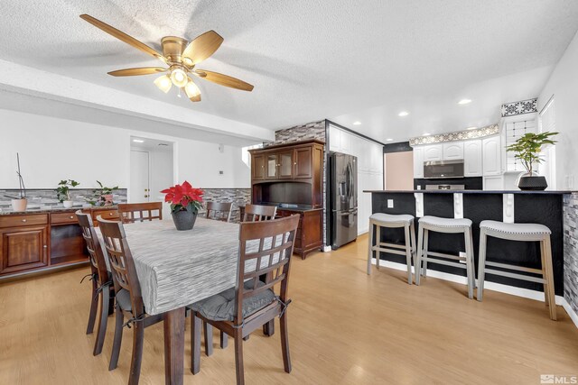6357 Moon Ridge Ter, Reno, NV 89523 - dining room with light wood-style floors, ceiling fan, and a textured ceiling