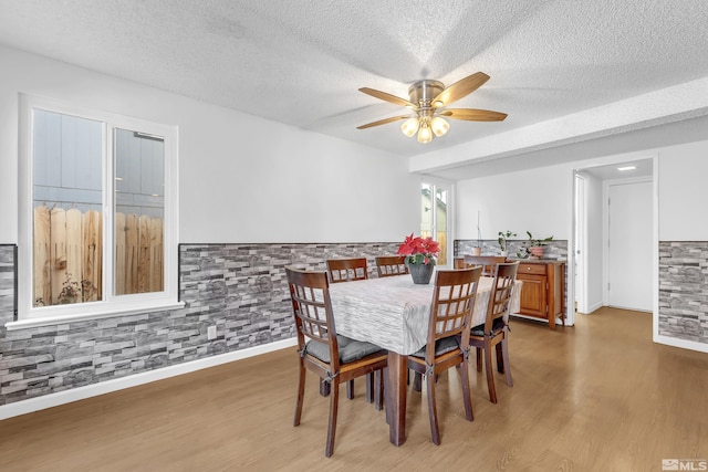 6357 Moon Ridge Ter, Reno, NV 89523 - dining room featuring wood finished floors, a textured ceiling, and a ceiling fan