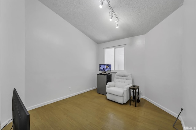 6357 Moon Ridge Ter, Reno, NV 89523 - living area with a textured ceiling, wood finished floors, baseboards, and track lighting
