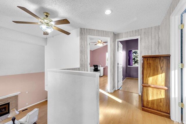 6357 Moon Ridge Ter, Reno, NV 89523 - hall featuring a textured ceiling, wood finished floors, baseboards, and an upstairs landing
