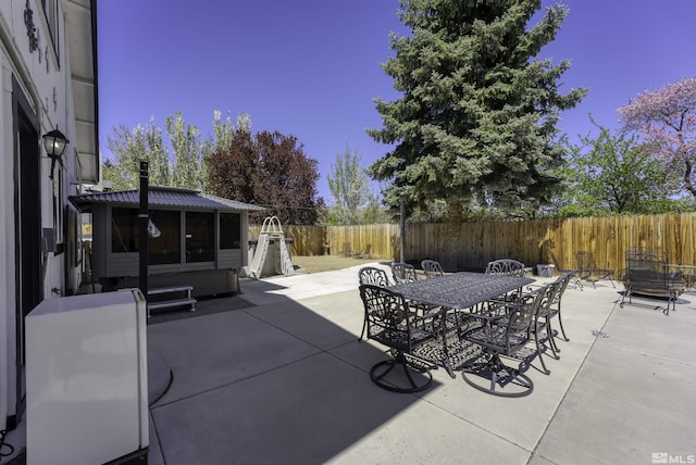 6357 Moon Ridge Ter, Reno, NV 89523 - view of patio / terrace featuring outdoor dining space, a fenced backyard, and a sunroom