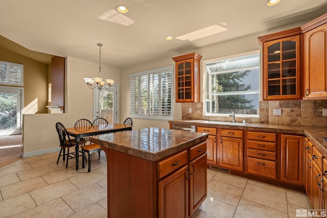 6540 Monticello Ct, Reno, NV 89519 - kitchen with a chandelier, decorative backsplash, brown cabinetry, and recessed lighting