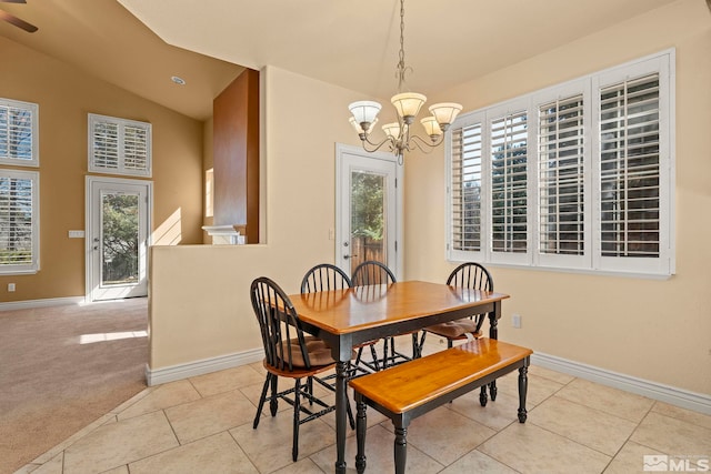 6540 Monticello Ct, Reno, NV 89519 - dining area featuring a chandelier, baseboards, tile patterned floors, and vaulted ceiling