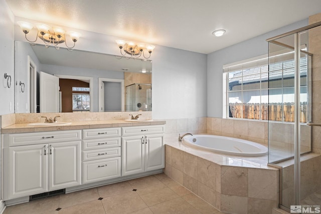 6540 Monticello Ct, Reno, NV 89519 - bathroom featuring a chandelier, a shower stall, a bath, double vanity, and tile patterned floors
