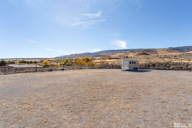 80 Cassas Ct, Reno, NV 89511 - view of yard with a mountain view, fence, a storage unit, an outdoor structure, and a view of rural / pastoral area