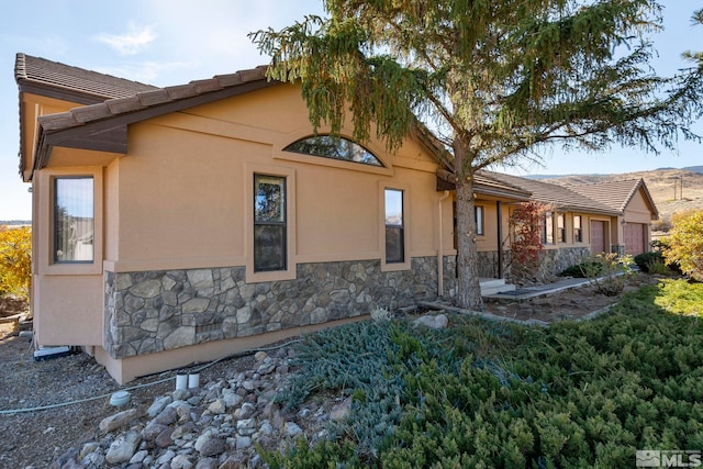 80 Cassas Ct, Reno, NV 89511 - back of house featuring stone siding and stucco siding