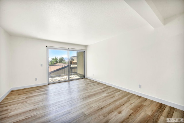 2555 Clear Acre Ln Unit 89/2, Reno, NV 89512 - spare room with light wood-type flooring, baseboards, and a textured ceiling