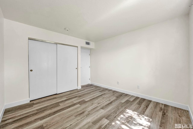 2555 Clear Acre Ln Unit 89/2, Reno, NV 89512 - unfurnished bedroom with wood finished floors, baseboards, and a closet