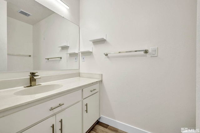 2555 Clear Acre Ln Unit 89/2, Reno, NV 89512 - bathroom with wood finished floors, baseboards, and vanity