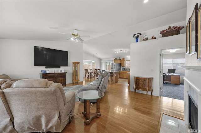 1018 Ringneck, Sparks, NV 89441 - living area featuring a fireplace with flush hearth, a ceiling fan, light wood finished floors, and lofted ceiling