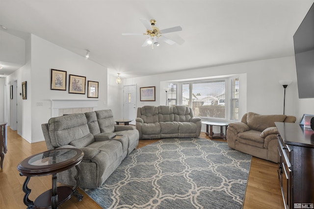 1018 Ringneck, Sparks, NV 89441 - living room with vaulted ceiling, wood finished floors, ceiling fan, and a tiled fireplace
