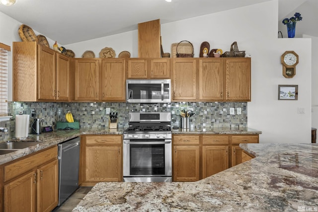 1018 Ringneck, Sparks, NV 89441 - kitchen featuring stainless steel appliances, vaulted ceiling, backsplash, and light stone counters