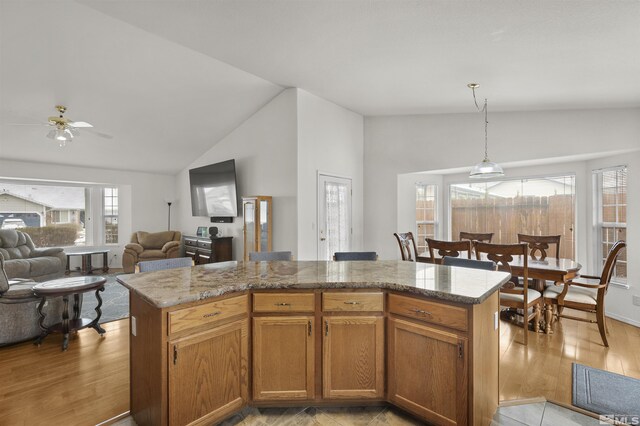 1018 Ringneck, Sparks, NV 89441 - kitchen featuring vaulted ceiling, a ceiling fan, a center island, light wood-style floors, and open floor plan