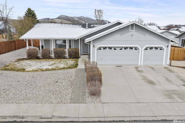 1018 Ringneck, Sparks, NV 89441 - ranch-style home with an attached garage, concrete driveway, fence, and a mountain view
