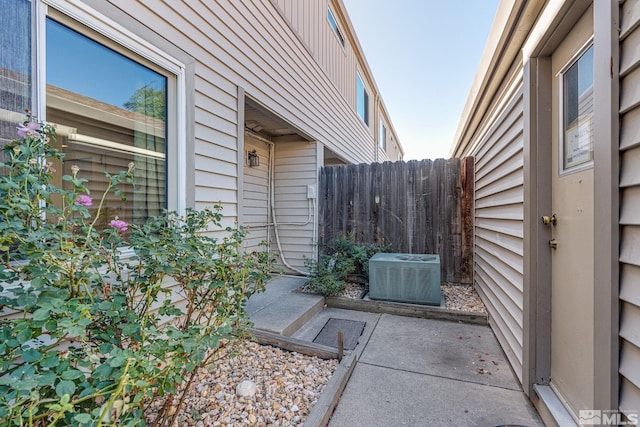 13846 Lear Blvd, Reno, NV 89506 - view of side of home featuring central AC unit, fence, and a patio