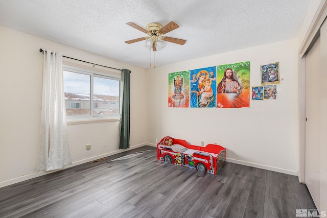 13846 Lear Blvd, Reno, NV 89506 - playroom featuring wood finished floors, a ceiling fan, a textured ceiling, and baseboards