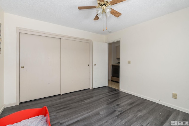13846 Lear Blvd, Reno, NV 89506 - unfurnished bedroom with dark wood finished floors, washer / clothes dryer, a closet, baseboards, and a textured ceiling