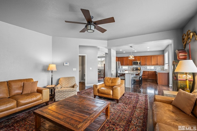 385 Mustengo Ct, Reno, NV 89506 - living area with a ceiling fan, recessed lighting, dark wood-style floors, and baseboards