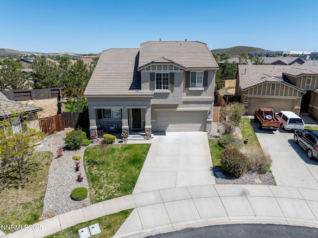 385 Mustengo Ct, Reno, NV 89506 - view of front facade featuring concrete driveway, stucco siding, a tiled roof, stone siding, and a mountain view