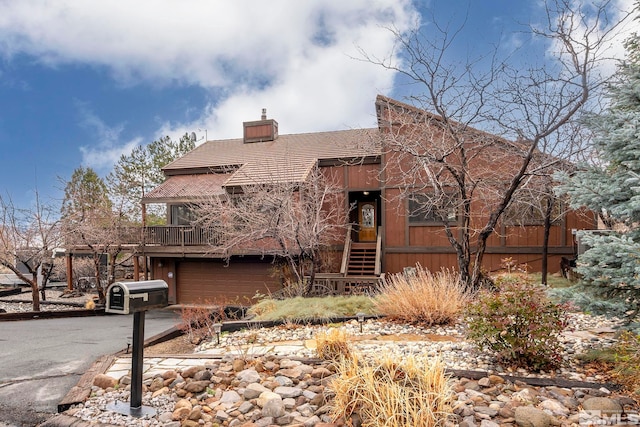 12880 Roseview Ln, Reno, NV 89511 - chalet / cabin with a chimney, asphalt driveway, and a garage