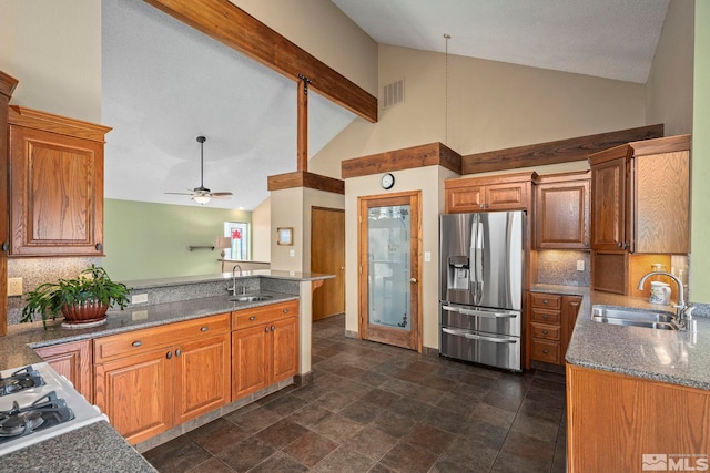 12880 Roseview Ln, Reno, NV 89511 - kitchen with stainless steel fridge, a sink, a peninsula, high vaulted ceiling, and tasteful backsplash