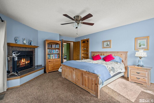 12880 Roseview Ln, Reno, NV 89511 - bedroom featuring carpet floors, a fireplace, a textured ceiling, and a ceiling fan