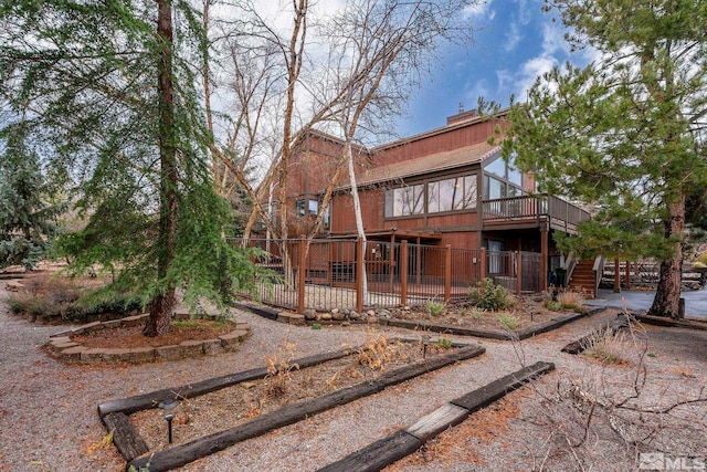 12880 Roseview Ln, Reno, NV 89511 - rear view of house with a deck, stairway, and a chimney