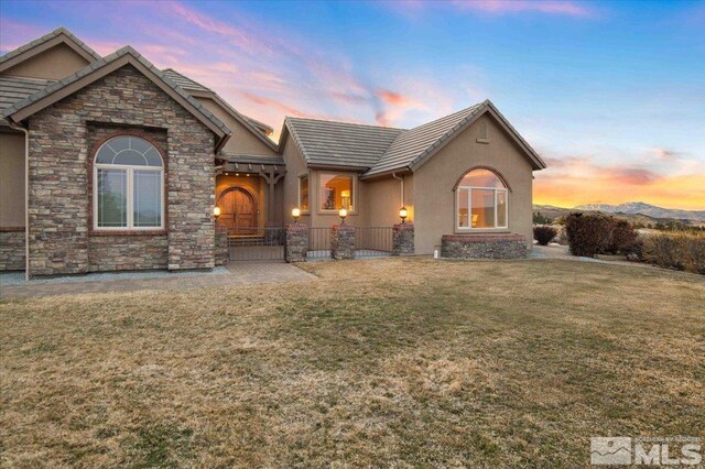 1005 Desert Jewel Ct, Reno, NV 89511 - view of front of home with stucco siding, stone siding, and a tiled roof