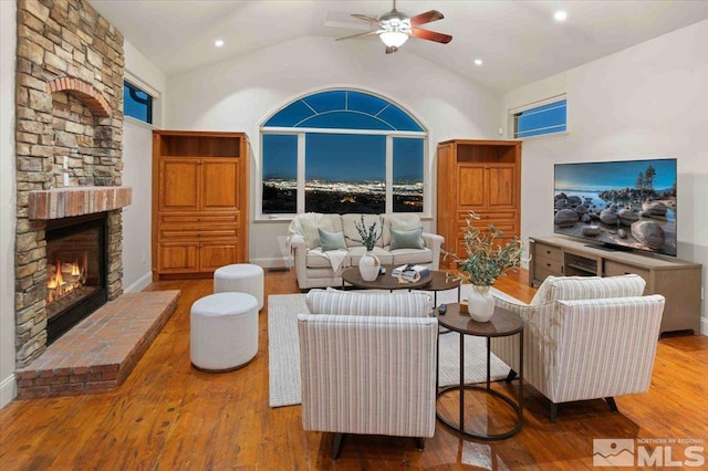 1005 Desert Jewel Ct, Reno, NV 89511 - living room featuring a ceiling fan, wood finished floors, a fireplace, high vaulted ceiling, and recessed lighting