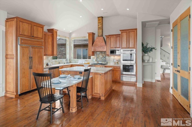 1005 Desert Jewel Ct, Reno, NV 89511 - kitchen featuring appliances with stainless steel finishes, a warming drawer, a center island, light countertops, and lofted ceiling