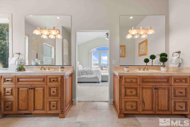1005 Desert Jewel Ct, Reno, NV 89511 - bathroom featuring two vanities, a ceiling fan, ensuite bathroom, and vaulted ceiling