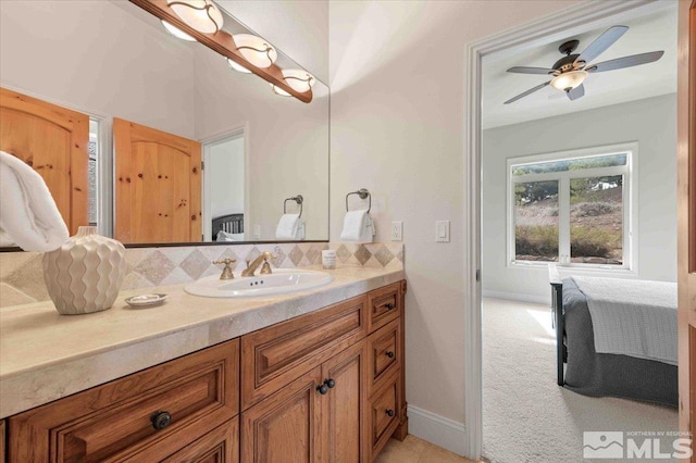 1005 Desert Jewel Ct, Reno, NV 89511 - bathroom with tasteful backsplash, vanity, baseboards, connected bathroom, and ceiling fan