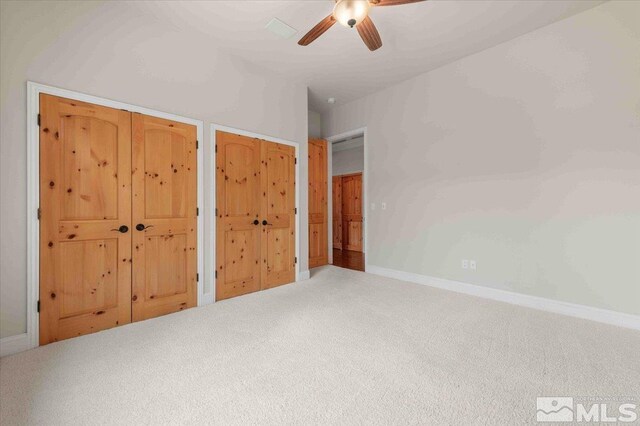 1005 Desert Jewel Ct, Reno, NV 89511 - unfurnished bedroom with carpet floors, baseboards, multiple closets, and a ceiling fan