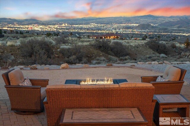 1005 Desert Jewel Ct, Reno, NV 89511 - patio terrace at dusk with a mountain view and an outdoor living space with a fire pit