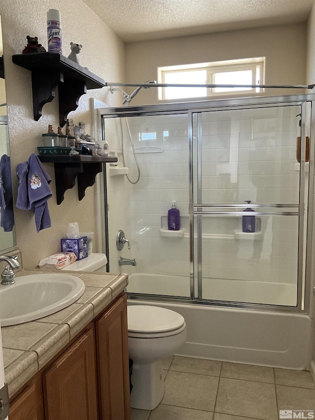 5710 Sarah Rd, Fallon, NV 89406 - bathroom featuring toilet, a textured ceiling, tile patterned flooring, enclosed tub / shower combo, and vanity
