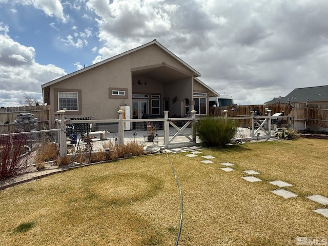 5710 Sarah Rd, Fallon, NV 89406 - rear view of house with stucco siding, a patio area, and french doors