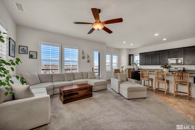 living area featuring a ceiling fan and recessed lighting