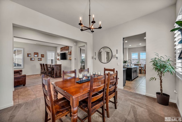dining space featuring light carpet, light tile patterned flooring, a chandelier, recessed lighting, and baseboards