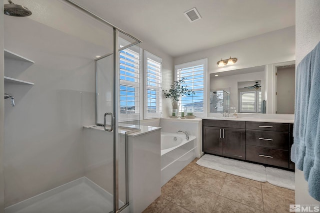 full bathroom with a stall shower, vanity, a bath, and tile patterned flooring
