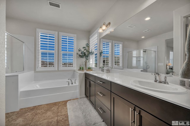 bathroom with a shower stall, a bath, double vanity, tile patterned flooring, and recessed lighting