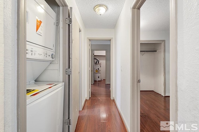 2375 Tripp Dr, Reno, NV 89512 - hallway with stacked washer / drying machine, wood finished floors, and a textured ceiling