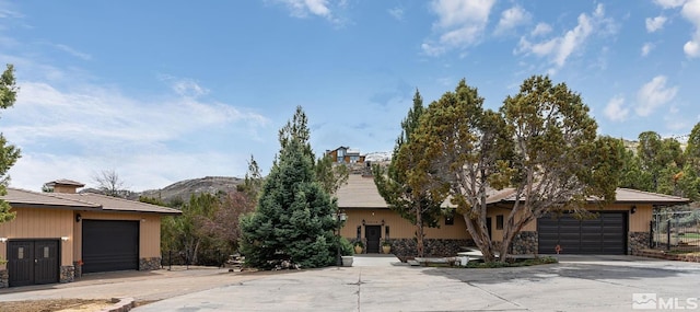 4840 Keshmiri Pl, Reno, NV 89519 - obstructed view of property with stone siding, a mountain view, and a garage